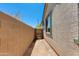 Showing the side yard of the home with a block wall, stucco exterior, gate and space for storage or a garden at 14188 W Artemisa Ave, Surprise, AZ 85387