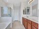 Elegant bathroom boasts double sinks, soaking tub, and glass-enclosed shower at 15093 W Glenrosa Ave, Goodyear, AZ 85395