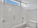 Bright bathroom featuring a tub with shower and a toilet at 15093 W Glenrosa Ave, Goodyear, AZ 85395