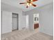 Bedroom featuring carpet flooring, ceiling fan, closet, and bathroom entrance at 15093 W Glenrosa Ave, Goodyear, AZ 85395