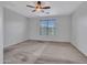 Neutral bedroom with carpet features a ceiling fan and a window with blinds at 15093 W Glenrosa Ave, Goodyear, AZ 85395