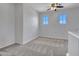 Upstairs bedroom with neutral carpet and light; ample natural light from two windows at 15093 W Glenrosa Ave, Goodyear, AZ 85395