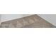 Close up of neutrally patterned carpet against a white wall at 15093 W Glenrosa Ave, Goodyear, AZ 85395