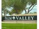 Attractive stone Palm Valley community sign surrounded by lush green landscaping at 15093 W Glenrosa Ave, Goodyear, AZ 85395