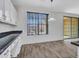 Bright dining area with a large window, stylish light fixture, and sliding glass door at 15093 W Glenrosa Ave, Goodyear, AZ 85395