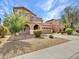 Charming two-story home featuring a tile roof, arched entryway, and a well-maintained, low-water front yard at 15093 W Glenrosa Ave, Goodyear, AZ 85395