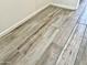 Close-up of wood-look tile flooring with neutral tones and subtle wood grain pattern at 15093 W Glenrosa Ave, Goodyear, AZ 85395