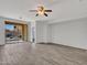 Bright room features wood-look tile flooring and access to a large sliding glass door to the backyard at 15093 W Glenrosa Ave, Goodyear, AZ 85395