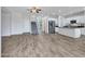 Bright living room with wood-look flooring leads to staircase and kitchen with island at 15093 W Glenrosa Ave, Goodyear, AZ 85395
