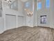 Expansive living room with high ceilings, large windows, and wood-look tile flooring at 15093 W Glenrosa Ave, Goodyear, AZ 85395
