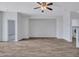 Room with wood-look tile flooring features open doorway and ceiling fan at 15093 W Glenrosa Ave, Goodyear, AZ 85395
