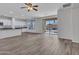 Open-concept space with wood-look flooring and access to a sliding glass door to the backyard at 15093 W Glenrosa Ave, Goodyear, AZ 85395