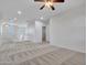 Open loft area featuring neutral walls, carpet, ceiling fans, a white railing, and natural light at 15093 W Glenrosa Ave, Goodyear, AZ 85395