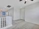 Cozy loft area featuring neutral walls, carpet, a ceiling fan, a white railing and natural light at 15093 W Glenrosa Ave, Goodyear, AZ 85395