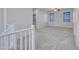 Bright loft area featuring neutral walls, carpet, a ceiling fan, a white railing and natural light at 15093 W Glenrosa Ave, Goodyear, AZ 85395