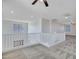 Bright loft space featuring neutral walls, carpet, a ceiling fan, and a white railing overlooking the lower floor at 15093 W Glenrosa Ave, Goodyear, AZ 85395