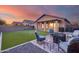 Beautiful backyard showcasing artificial turf, an outdoor seating area, and a desert-style fence for privacy at 15155 W Desert Hills Dr, Surprise, AZ 85379