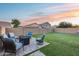 Serene backyard retreat featuring a well-manicured lawn and an inviting patio area with comfortable seating at 15155 W Desert Hills Dr, Surprise, AZ 85379