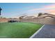 Spacious backyard with low maintenance artificial turf and desert rock landscaping at 15155 W Desert Hills Dr, Surprise, AZ 85379