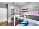 A bedroom with wood floors and a unique bunk bed is seen in a closet mirror at 15155 W Desert Hills Dr, Surprise, AZ 85379