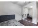 This bedroom has a bed with gray headboard, wood floors and mirrored closet doors at 15155 W Desert Hills Dr, Surprise, AZ 85379