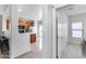 A bright kitchen is adjacent to an entry area and has wooden cabinets, tile floors and stainless steel appliances at 15155 W Desert Hills Dr, Surprise, AZ 85379