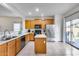 Spacious kitchen features wood cabinets, stainless steel appliances, and an island for food preparation at 15155 W Desert Hills Dr, Surprise, AZ 85379