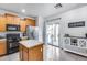 Bright kitchen featuring wood cabinets, an island, and sliding glass doors for easy access to outdoors at 15155 W Desert Hills Dr, Surprise, AZ 85379