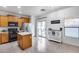 Open kitchen features an island, wood cabinets, and stainless steel appliances at 15155 W Desert Hills Dr, Surprise, AZ 85379