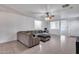 Spacious living room with neutral tile flooring, a comfy sectional, and an open layout for easy entertaining at 15155 W Desert Hills Dr, Surprise, AZ 85379