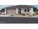 Inviting single-story home featuring a neutral color palette, desert landscaping, and a two-car garage at 15776 W Beryl Ave, Waddell, AZ 85355