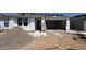 Image shows new home construction, exterior view, showing garage and building supplies at 15776 W Beryl Ave, Waddell, AZ 85355