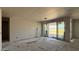 View of a spacious living room under construction with sliding glass doors and drywall at 15776 W Beryl Ave, Waddell, AZ 85355