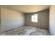 Image of new room with drywall, concrete floors, and a window at 15776 W Beryl Ave, Waddell, AZ 85355