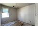 Image of an unfinished room showing drywall, window, and concrete floors at 15776 W Beryl Ave, Waddell, AZ 85355