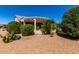 Lush desert backyard with a covered patio, providing a tranquil space for outdoor living and entertaining at 15936 W Clear Canyon Dr, Surprise, AZ 85374