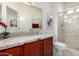This bathroom includes a granite-topped vanity and a tiled glass-enclosed shower at 15936 W Clear Canyon Dr, Surprise, AZ 85374