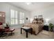 Comfortable bedroom with plantation shutters, ceiling fan, and neutral decor at 15936 W Clear Canyon Dr, Surprise, AZ 85374