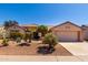 Charming single-story home with a well-manicured desert landscape and a two-car garage at 15936 W Clear Canyon Dr, Surprise, AZ 85374