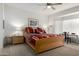 Serene main bedroom featuring natural light, ceiling fan, and comfortable furnishings at 15936 W Clear Canyon Dr, Surprise, AZ 85374
