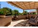 Serene covered patio with lush landscaping offers a tranquil space for relaxation and enjoying the outdoors at 15936 W Clear Canyon Dr, Surprise, AZ 85374