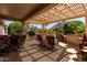 Shaded patio area perfect for outdoor dining and relaxation, with views of greenery at 15936 W Clear Canyon Dr, Surprise, AZ 85374