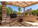Inviting covered patio with built-in grill, perfect for outdoor cooking and entertaining on a sunny day at 15936 W Clear Canyon Dr, Surprise, AZ 85374