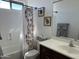 Bright bathroom featuring a bathtub with shower, white vanity, and stylish floral shower curtain at 16401 S 29Th Dr, Phoenix, AZ 85045