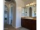 Bathroom with wooden cabinets and double sinks with access to the main bedroom at 16401 S 29Th Dr, Phoenix, AZ 85045