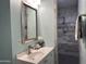 Stylish bathroom showcasing a modern sink, vanity, decorative mirror, and a walk-in tiled shower at 16401 S 29Th Dr, Phoenix, AZ 85045