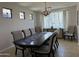 Formal dining room with a large table, decorative chandelier, and lots of natural light at 16401 S 29Th Dr, Phoenix, AZ 85045
