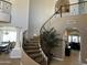 Open foyer featuring a winding staircase with rod iron spindles and neutral finishes at 16401 S 29Th Dr, Phoenix, AZ 85045