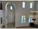 Grand foyer with high ceilings, decorative chandelier, elegant staircase, and lots of natural light at 16401 S 29Th Dr, Phoenix, AZ 85045
