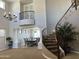 Elegant foyer with a winding staircase, chandelier, and soaring ceilings at 16401 S 29Th Dr, Phoenix, AZ 85045